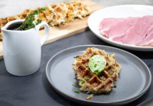 CORNED BEEF HASH WAFFLE WITH THYME MAPLE SYRUP AND HERB COMPOUND BUTTER Image