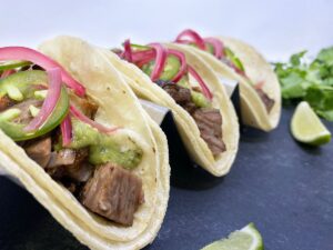 BRISKET BURNT ENDS TACOS WITH PICKLED RED ONIONS AND SALSA VERDE